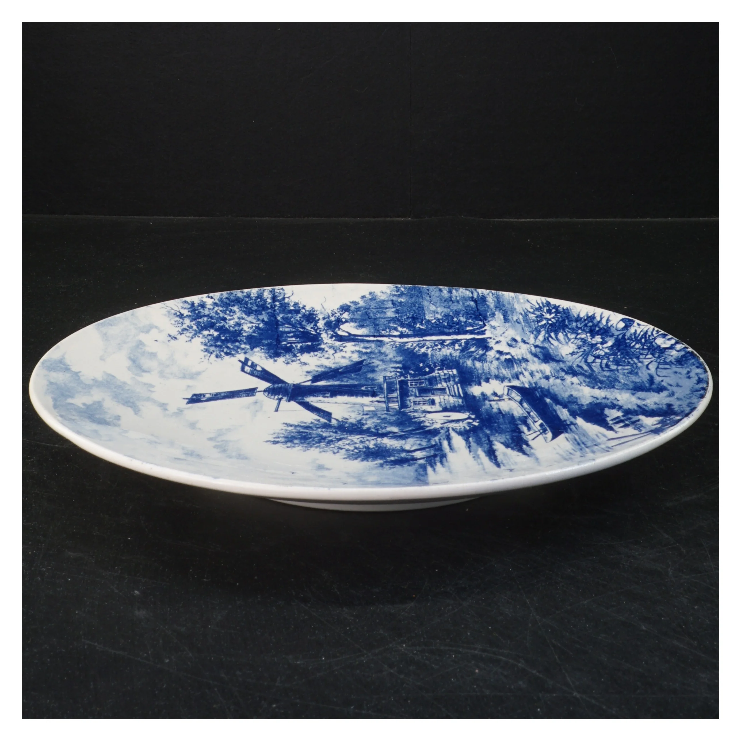 Dekorativt porcelænstallerken med landskab (str. 26 cm)