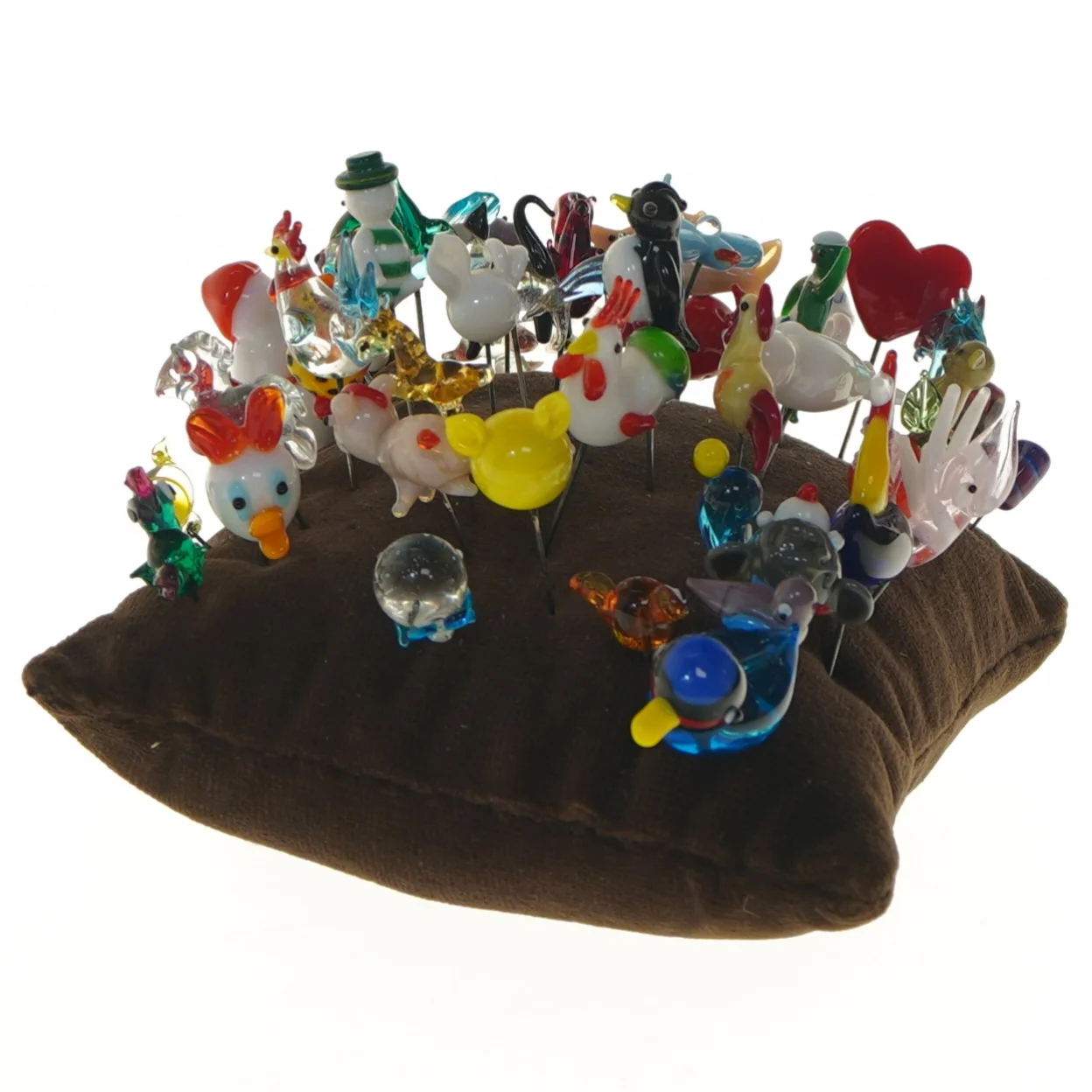 Samling af nipsenåle på pude (str. 15x15 cm)