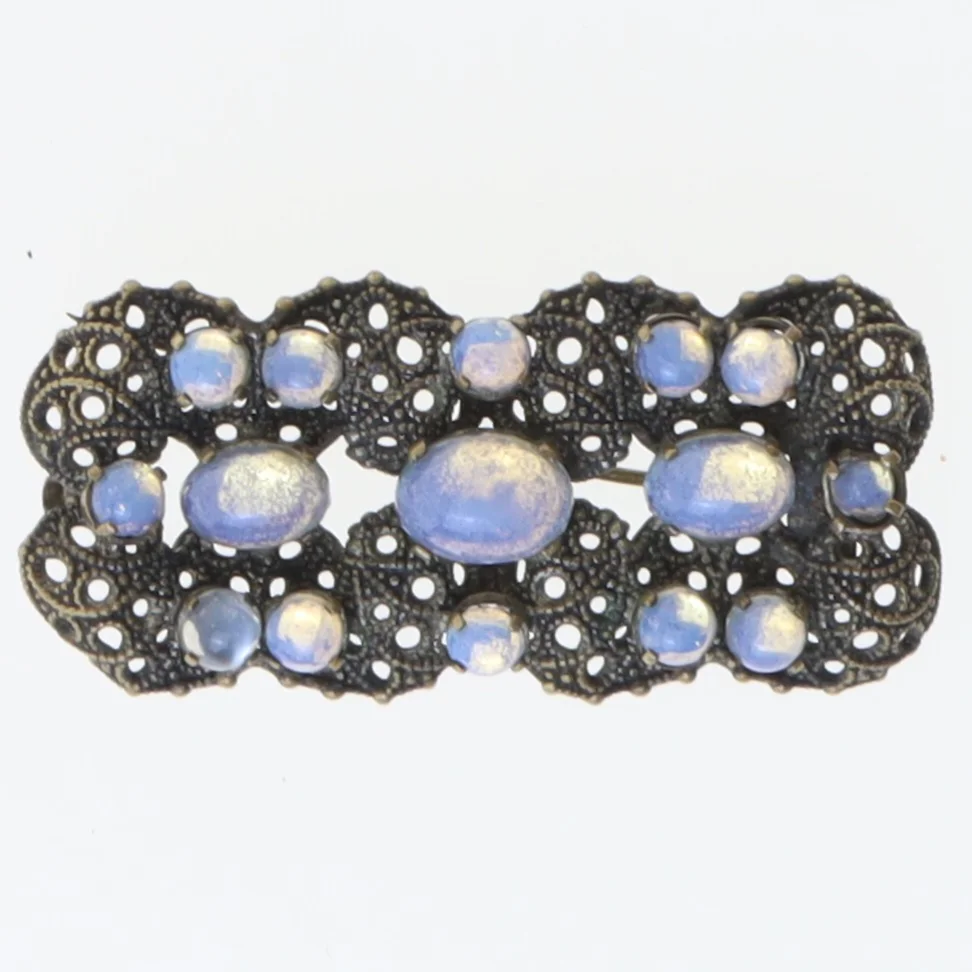 Dekorativ broche med blå sten (str. 5,5x2,5 cm)