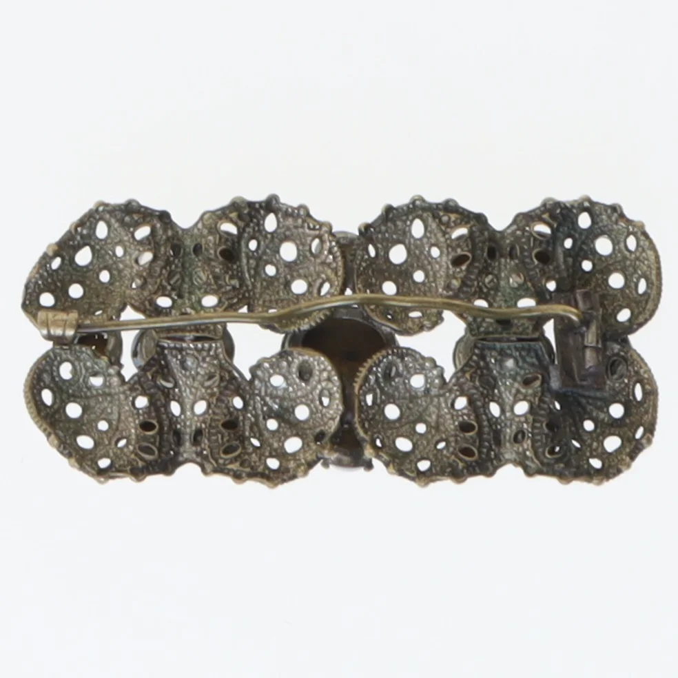 Dekorativ broche med blå sten (str. 5,5x2,5 cm)